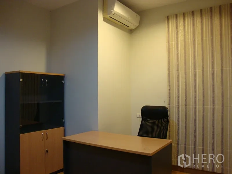 Condominium for rent in Khlong Toei, Bangkok - Quiet study or office room with desk, black chair, cabinet and air conditioner.