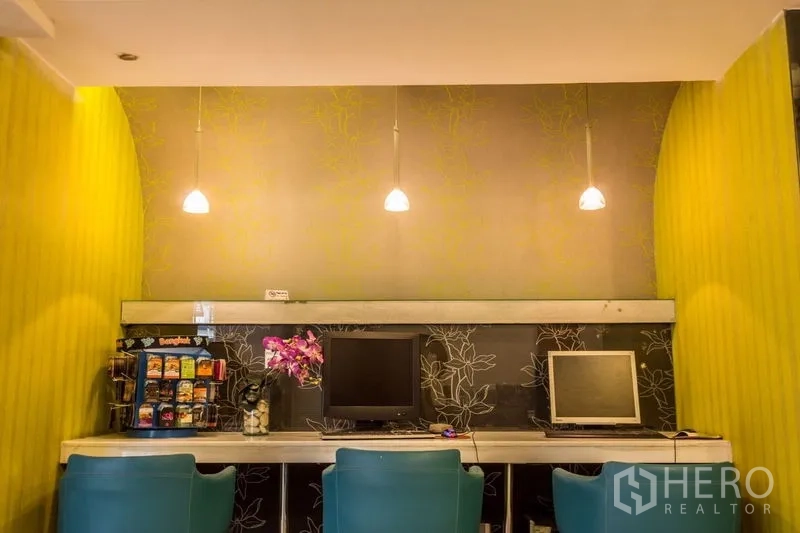 Retail Space for rent - Workstation nook with pendant lights, computers and a snack display.