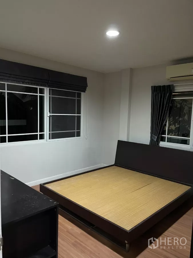 Detached House for rent in Bang Kapi, Bangkok - Third bedroom angle showing large sliding wardrobe and wood flooring.