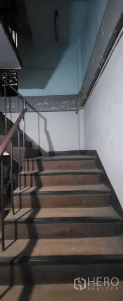 Shophouse for rent in Khlong Toei, Bangkok - Internal staircase with metal railing leading to upper levels.