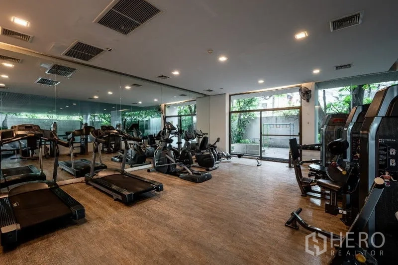 Condominium for sale - Condominium fitness room with treadmills, bikes and mirrored wall.