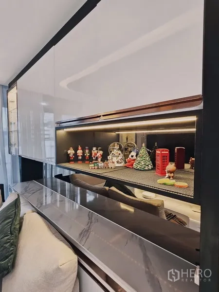 Condominium for sale in Bang Rak, Bangkok - Close-up of illuminated display shelf and marble ledge in the living area.