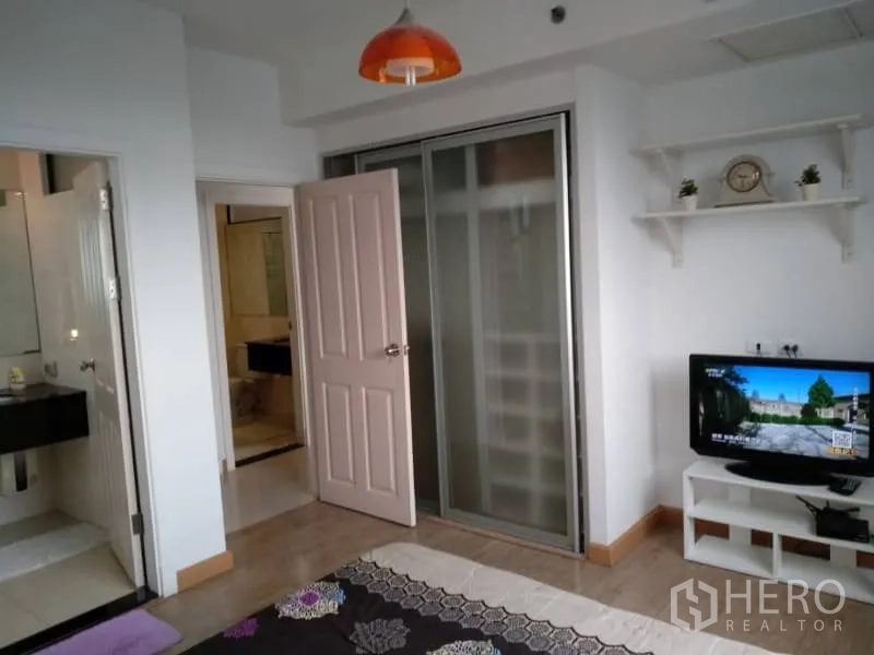 公寓 出租在Watthana, Bangkok - 卧室一角，推拉门衣柜、墙架与小电视柜