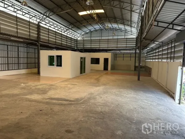 Warehouse for rent in Bueng Kum, Bangkok - Spacious warehouse interior with high clear-span roof and built-in office rooms.