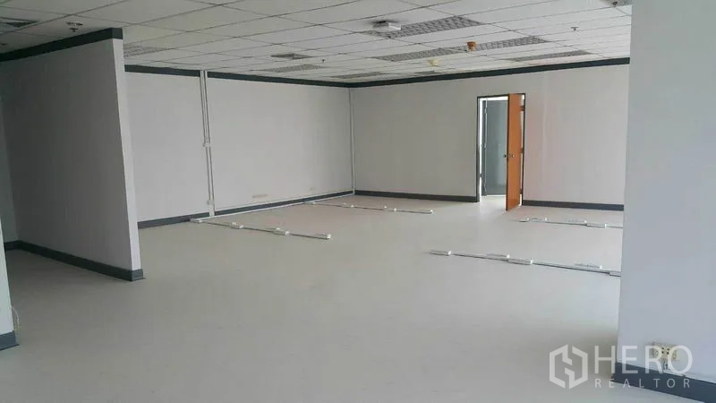 Office Space for rent in Khlong Toei, Bangkok - Spacious workspace featuring drop ceiling, neutral finishes, and floor cable trunking.