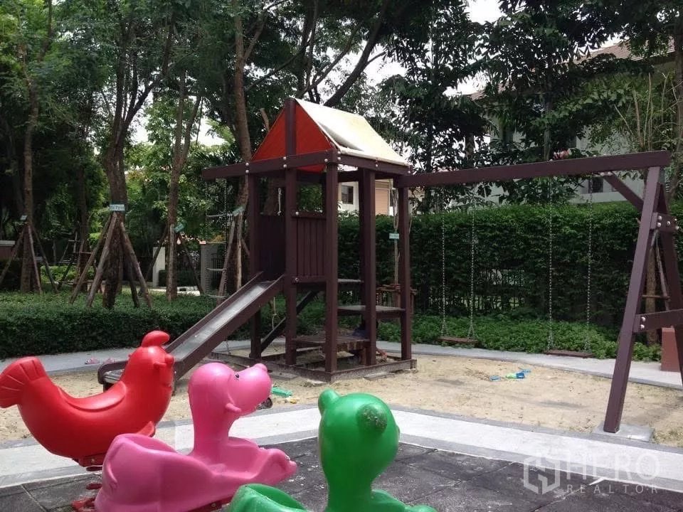 Detached House for sale in Bang Phli, Samut Prakan - Children’s playground with slide and swings in a shaded garden.