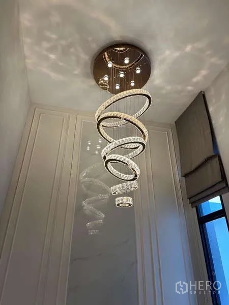 Detached House for rent in Bang Phli, Samut Prakan - Close-up of spiral crystal chandelier hanging from a high ceiling.