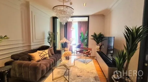 Condominium for rent in Khlong Toei, Bangkok - Cozy lounge with TV wall, crystal chandelier, sliding glass to a sunroom and warm wood flooring.