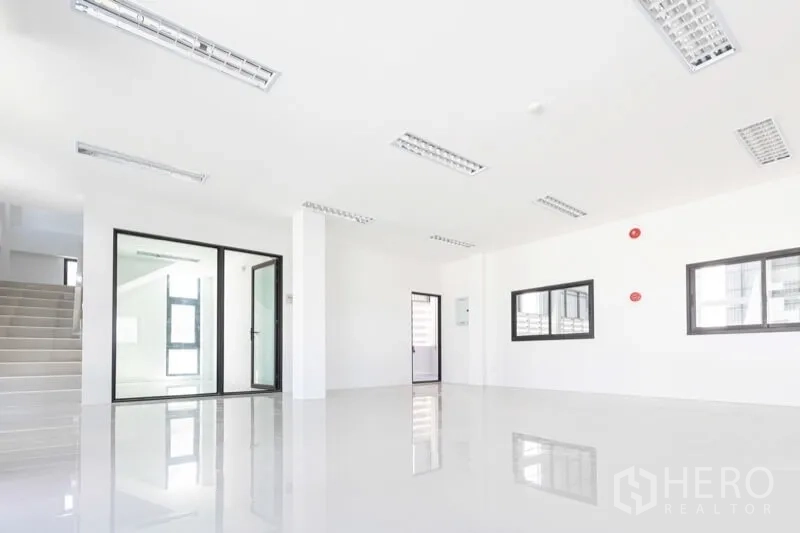 Warehouse for rent in Bang Bo, Samut Prakan - Clean office lobby with glass partitions, staircase and ceiling lighting.