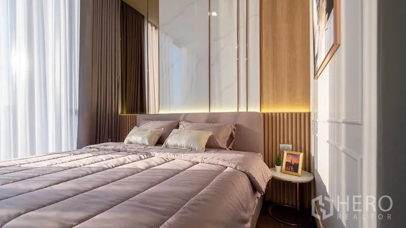 Condominium for rent in Watthana, Bangkok - Bright bedroom with large windows, sheer curtains, and a backlit headboard.