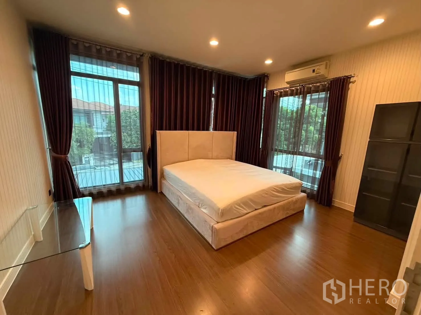 Detached House for rent in Bang Kapi, Bangkok - Corner master bedroom with large windows on two sides and dark drapes.