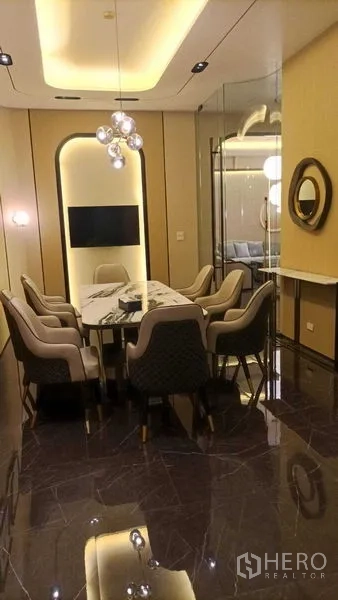 Retail Space for rent - Fitted meeting room featuring a marble table, upholstered chairs, TV and glass partition.