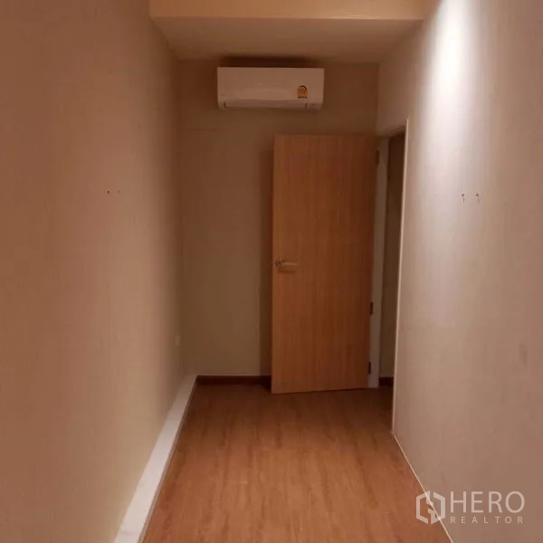 Shophouse for rent in Watthana, Bangkok - Narrow office or storage room with wood floor and wall-mounted air conditioner
