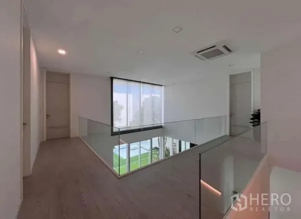 Detached House for sale in Bang Phli, Samut Prakan - Upstairs landing with glass balustrade overlooking the living room and garden.