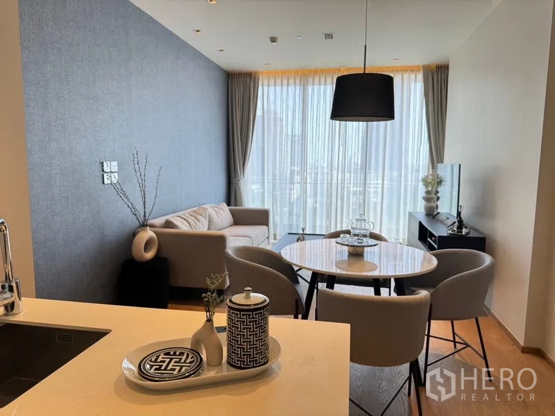 Condominium for rent - Living and dining space seen from kitchen island with decorative tray and vases.