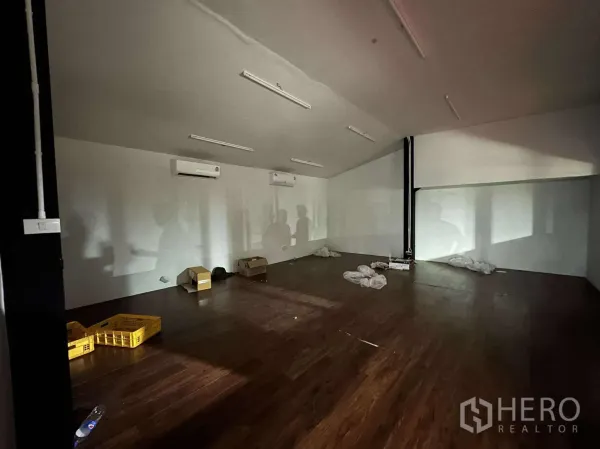 Warehouse for rent - Upper-floor office with wood-look flooring, split-type air conditioners and strip lighting.