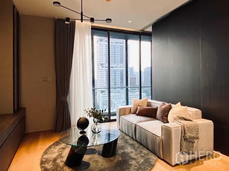 Condominium for rent or sale - Lounge facing balcony and skyline through full-height glass doors.