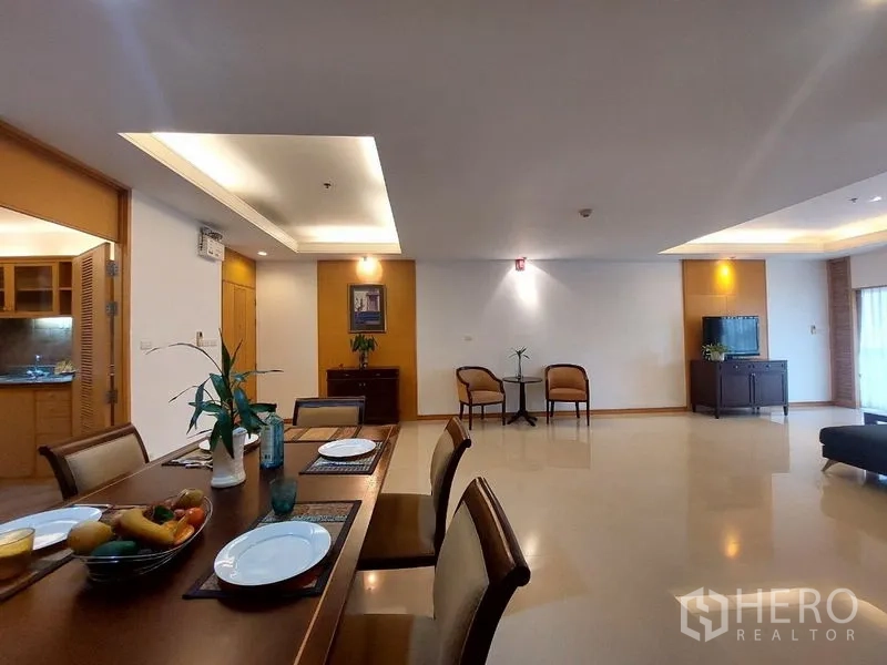 Apartment for rent - Open-plan dining and living area with table set, recessed ceilings and seating corners.
