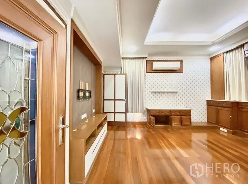 Home Office for rent in Pak Kret, Nonthaburi - Double-height living area with chandelier and floor-to-ceiling sliding glass opening to deck.