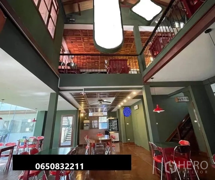 Retail Space for rent in Pathum Wan, Bangkok - Double-height retail interior with mezzanine, wood ceiling, pendant lights and cafe seating.
