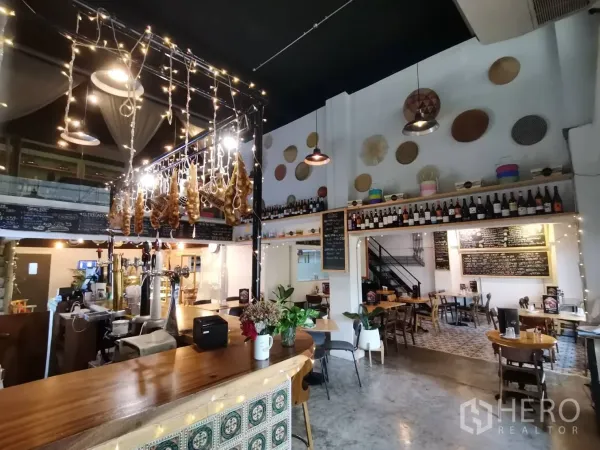Retail Space for rent in Watthana, Bangkok - Warm interior featuring a wooden bar counter, hanging lights and bottle display.