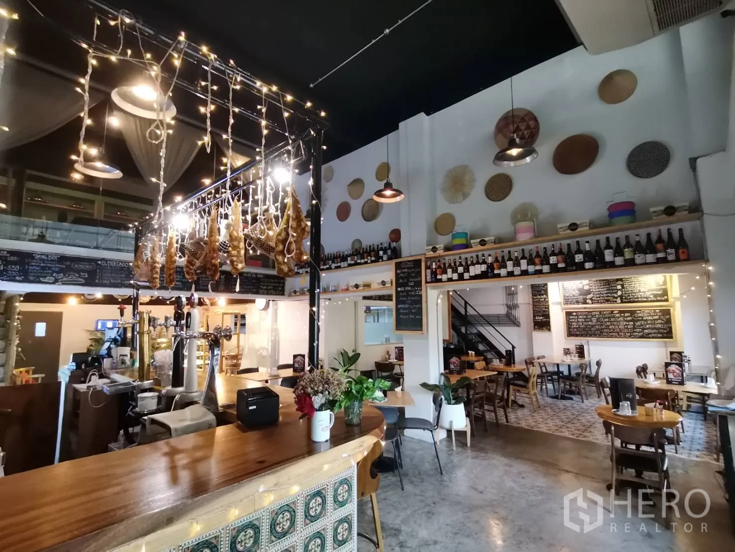 Retail Space for rent in Watthana, Bangkok - Warm interior featuring a wooden bar counter, hanging lights and bottle display.