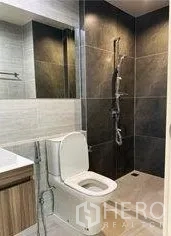 Home Office for rent in Don Mueang, Bangkok - Contemporary bathroom with dark-tile shower, toilet and vanity.