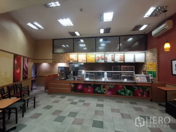 Shophouse for rent in Bangkok - Bright restaurant interior with service counter, menu boards, and tiled floor.