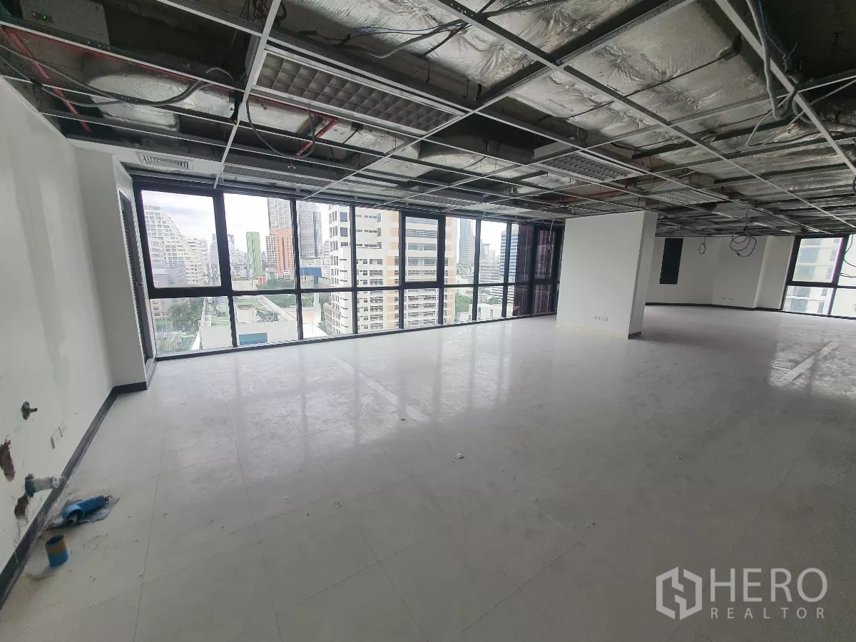 Office Space for rent in Bang Rak, Bangkok - Bright workspace with panoramic windows and structural column, ready for fit‑out.