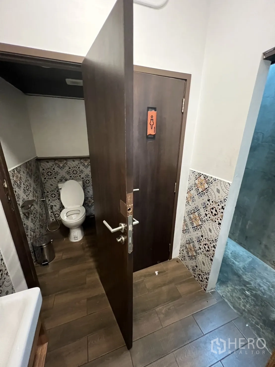 Retail Space for rent in Watthana, Bangkok - Clean restroom with patterned wall tiles, white fixtures and wood-look flooring.