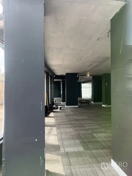 Retail Space for rent in Watthana, Bangkok - Retail space with unfinished ceiling, structural columns and a window‑lined wall.