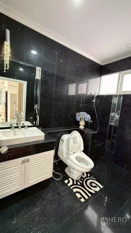 Detached House for rent or sale in Bang Phli, Samut Prakan - Bathroom with black stone tiles, vanity and toilet
