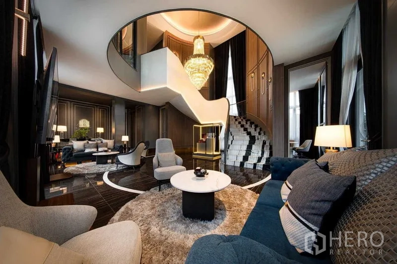 Detached House for sale in Saphan Sung, Bangkok - Grand living room with sweeping sculptural staircase, chandelier and plush seating zones.