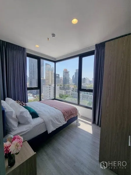公寓 出租在Watthana, Bangkok - 转角卧室配落地窗，眺望曼谷天际线景观。