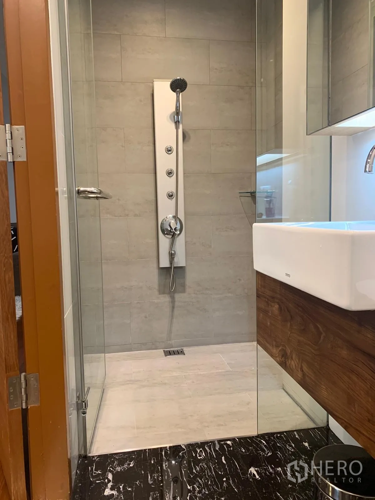 Condominium for sale in Khlong Toei, Bangkok - Glass shower with multi‑jet panel inside a tiled bathroom.