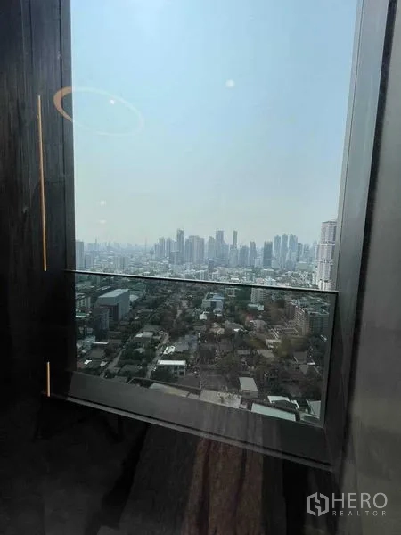 Condominium for rent in Khlong Toei, Bangkok - High‑floor window outlook across the Bangkok skyline and surrounding neighborhood.