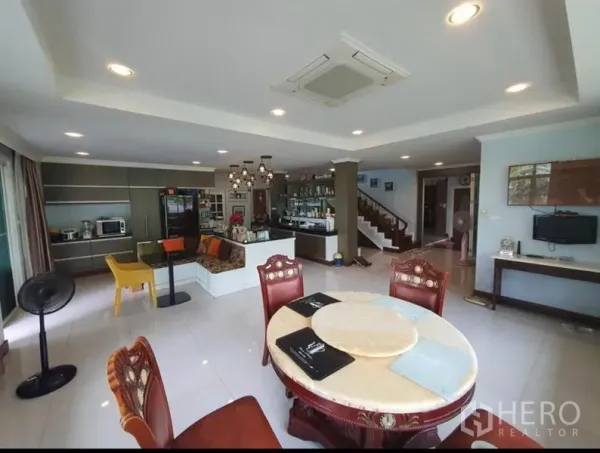 Detached House for sale in Sai Mai, Bangkok - Open-plan living and dining room with recessed lighting, staircase and bar counter.