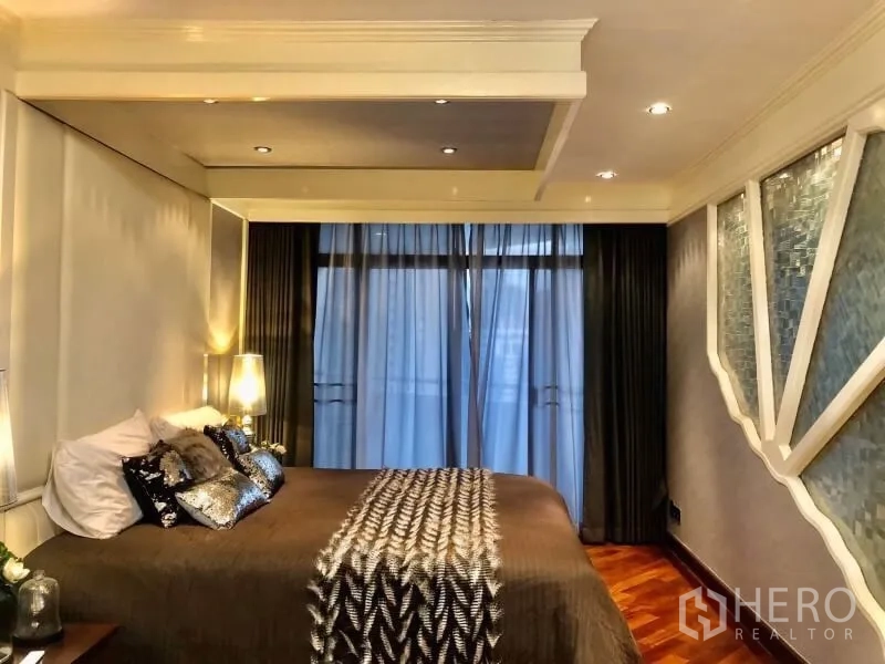 Condominium for rent in Watthana, Bangkok - Primary bedroom with tray ceiling, floor-to-ceiling windows and geometric accent wall