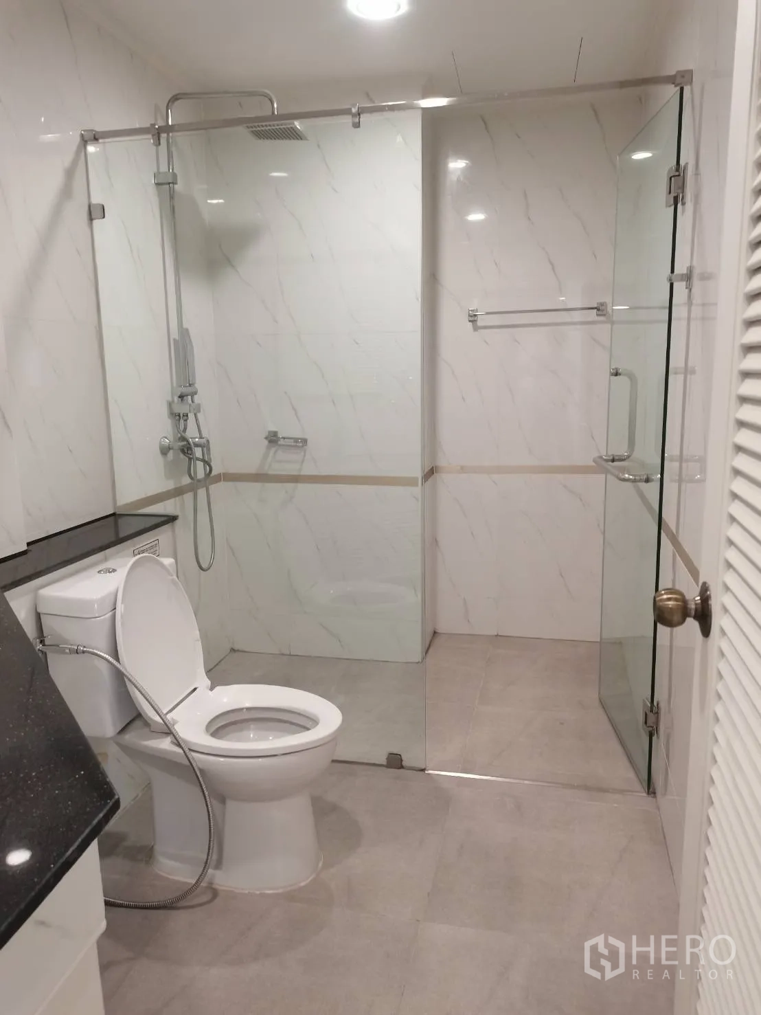 คอนโด for rent in Watthana, Bangkok - ห้องน้ำโมเดิร์น ฝักบัวเรนชาวเวอร์กั้นกระจก โถสุขภัณฑ์ และเคาน์เตอร์ท็อปสีดำ