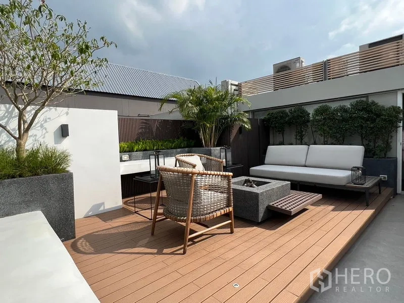 ทาวน์เฮาส์ ขายในLat Phrao, Bangkok - ดาดฟ้าระเบียงปูพื้นไม้เทียม พร้อมโซฟากลางแจ้งและกระถางต้นไม้