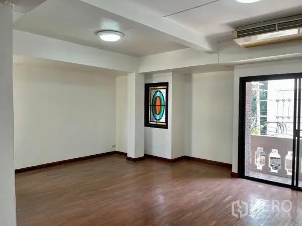 Home Office for rent in Khlong Toei, Bangkok - Bright open workspace with wood flooring, a stained-glass feature window and sliding door to a balcony.