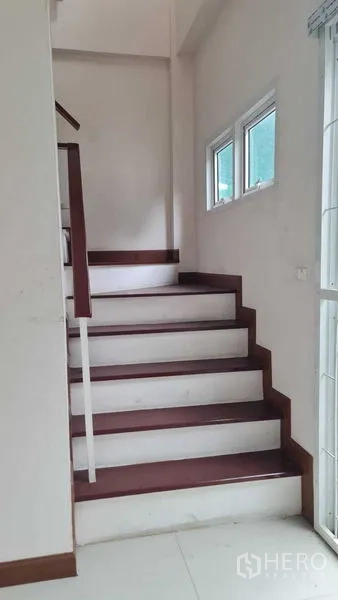 Townhouse for  in Lam Luk Ka, Pathum Thani - Staircase beside narrow windows leading to the upper level.