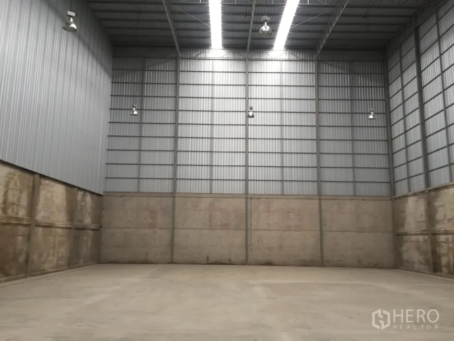 Warehouse for rent in Lam Luk Ka, Pathum Thani - Spacious warehouse interior with 12–16 m high steel ceiling, concrete floor and high-bay lights.