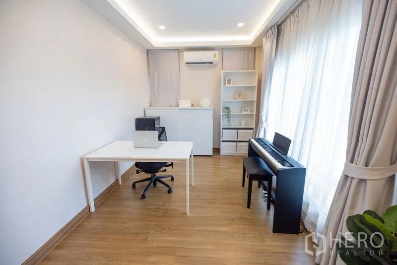 Detached House for rent or sale in Bang Phli, Samut Prakan - Light-filled home office and music room with desk, chair and digital piano.