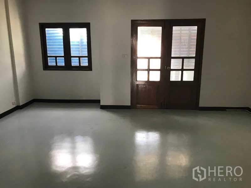 Office Space for rent in Khlong Toei, Bangkok - Open office area with window and wooden double doors ready for fit-out.