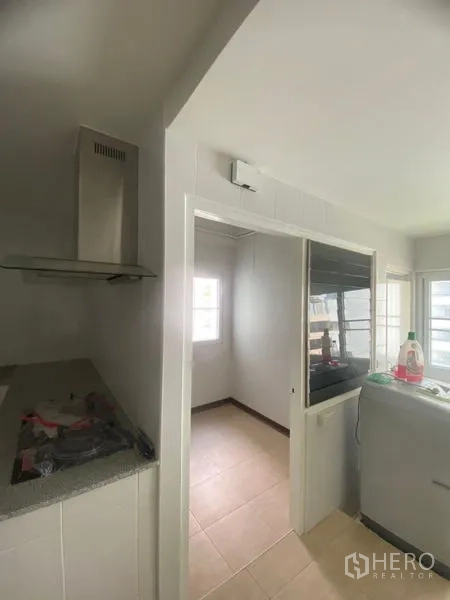 Condominium for rent in Sathon, Bangkok - Utility area off the kitchen with glass door, windows, and space for laundry equipment.