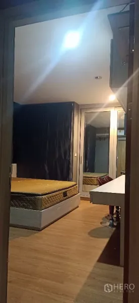 Detached House for rent or sale in Khan Na Yao, Bangkok - Bedroom view toward dressing table and built‑in closet with full-height mirror.