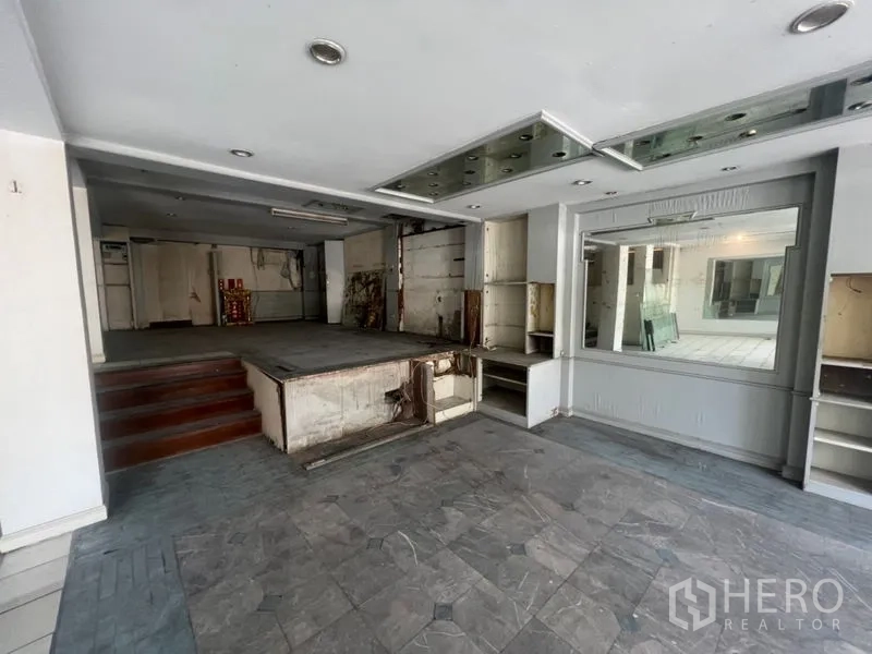 Retail Space for rent in Watthana, Bangkok - Front zone with raised platform, display shelving and recessed lights.