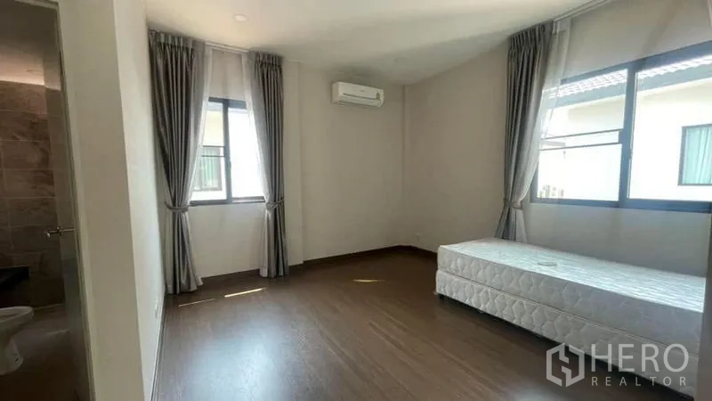 Detached House for rent or sale in Prawet, Bangkok - Covered entrance with stepping-stone path, double wooden doors and night lighting.