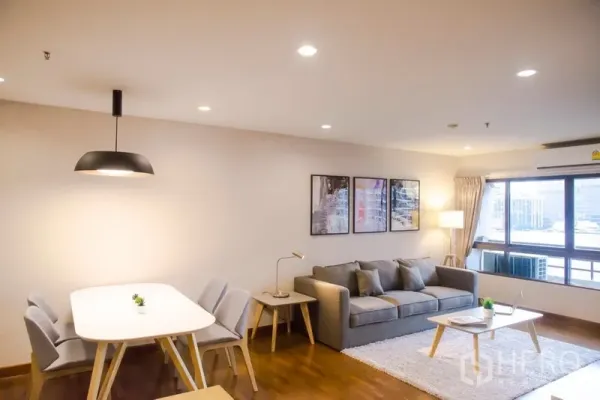 Condominium for rent in Pathum Wan, Bangkok - Dining area with pendant light beside a cozy lounge in a contemporary condo.